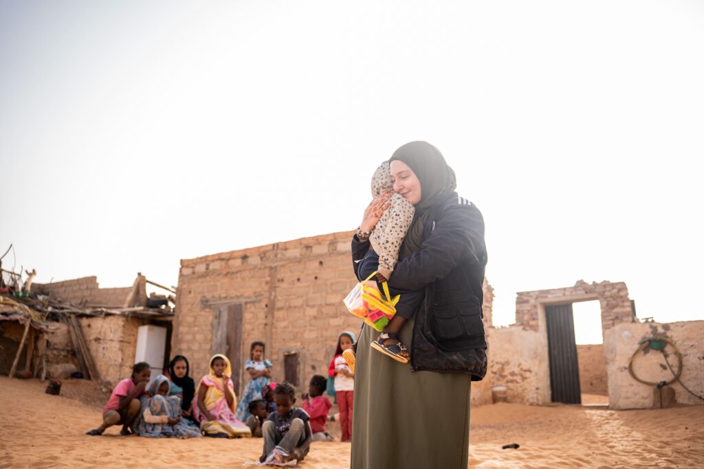 Orphelin qui fait un calin à une femme en Mauritanie.